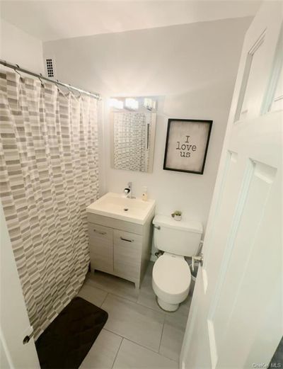 Updated bathroom with vanity, toilet, walk in shower, and tile patterned flooring | Image 3