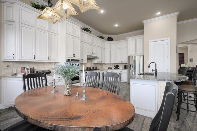 Breakfast and dining area looking toward the kitchen. | Image 13