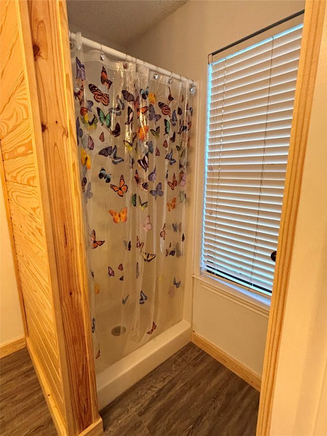 Full bath with wood finished floors and a shower stall | Image 20