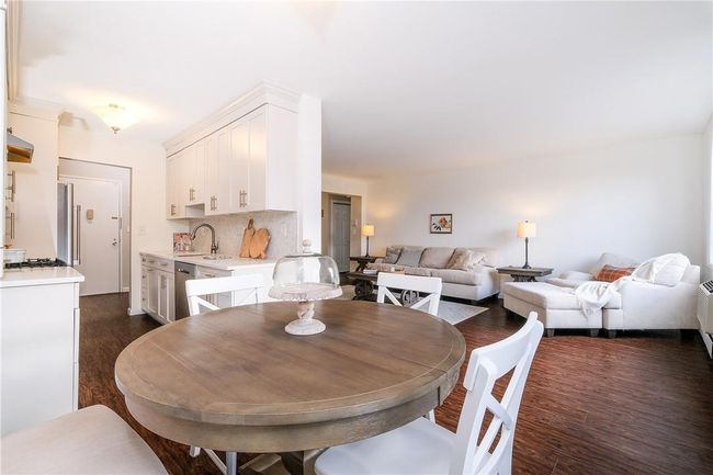 View from dining area towards kitchen and living area shows open-concept flow. | Image 11
