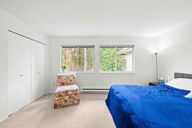 Carpeted bedroom featuring a closet and baseboard heating | Image 19
