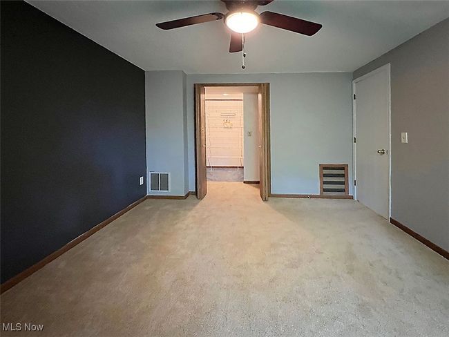 Second room with light carpet and a ceiling fan and walk-in closet | Image 15