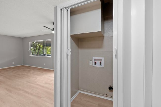 Laundry room featuring light wood finished floors, baseboards, hookup for a washing machine, ceiling fan, and laundry area | Image 8