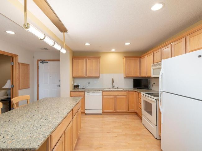 Center island with seating and additional storage. | Image 13