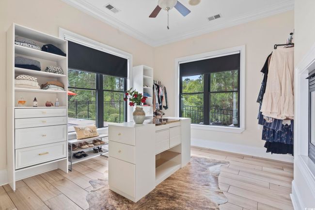 Spacious closet featuring a ceiling fan and light wood-style floors | Image 18