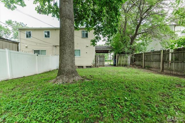 View of fenced backyard | Image 18