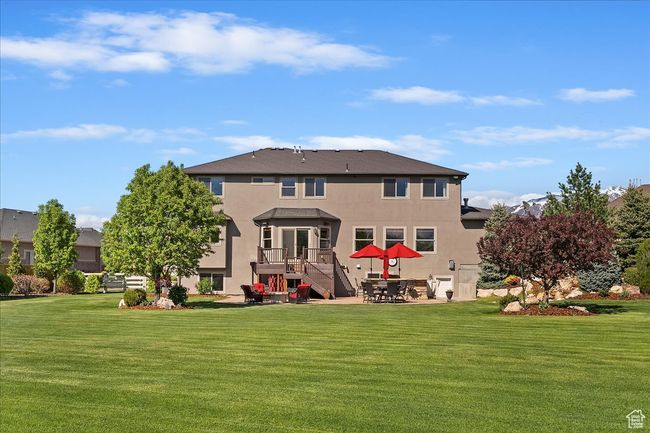 Rear view of property with a patio, stucco siding, and a yard | Image 56