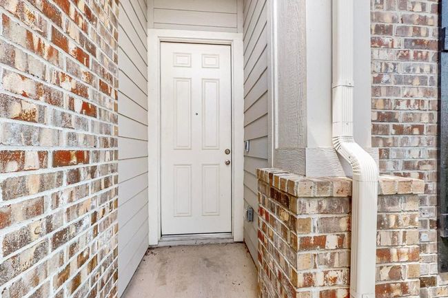 View of exterior entry with brick siding | Image 5