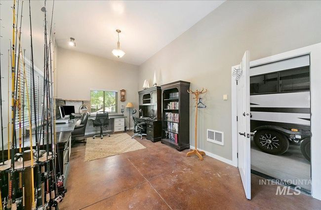 Office space featuring concrete flooring and high vaulted ceiling | Image 45