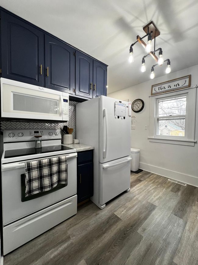 Kitchen with view of backyard. | Image 12