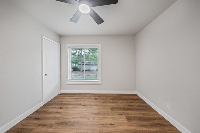 Spare room with ceiling fan and wood finished floors | Image 11