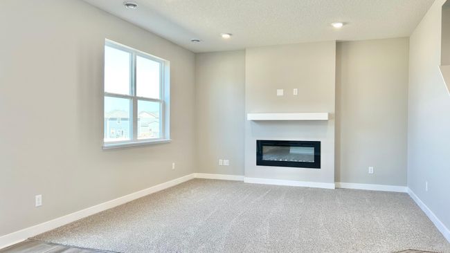 Photo of actual home! Main floor family room. Modern electric fireplace with mantel make this space cozy and on trend. | Image 11