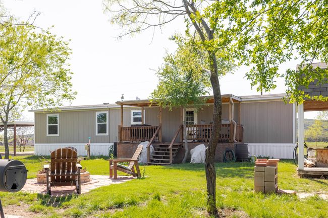 Back of house with a yard, a porch, and a patio | Image 29