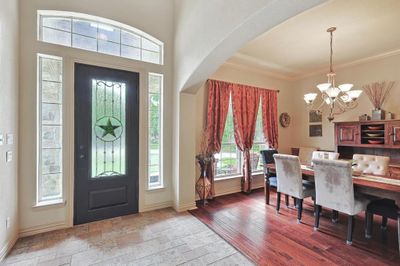 Foyer entrance featuring ornamental molding, a notable chandelier, and hardwood / wood-style floors | Image 3