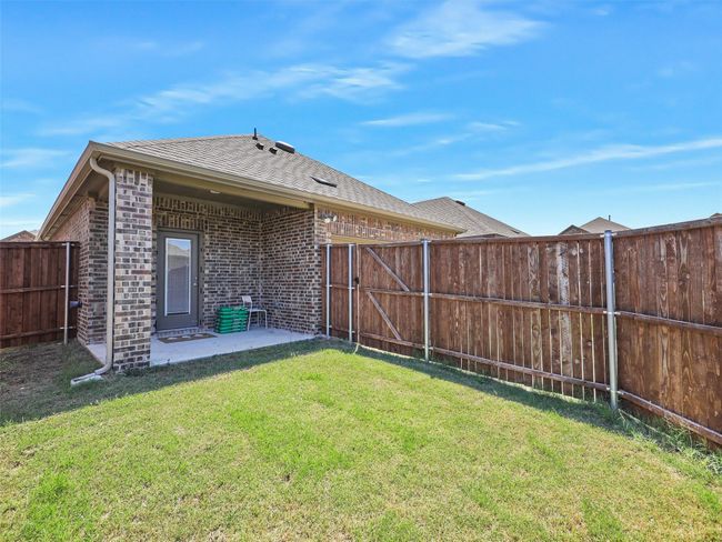 Fenced backyard with a patio area | Image 22