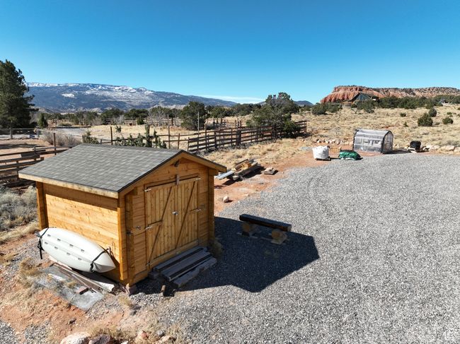 Exterior space with an outdoor structure, a storage unit, fence, and a mountain view | Image 45