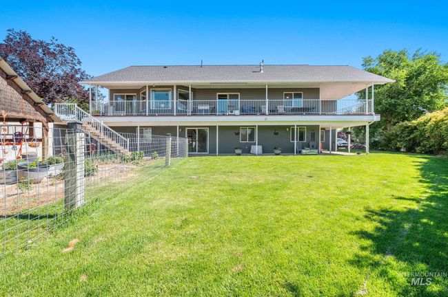 Back of property featuring a garden, yard, stairway to upper deck | Image 44