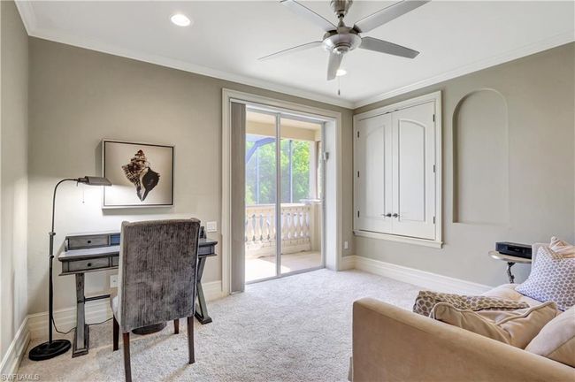 Office with ornamental molding, a ceiling fan, carpet, and baseboards | Image 6
