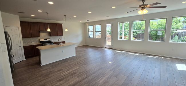 Living area with ceiling fan, open floorplan, recessed lighting | Image 6