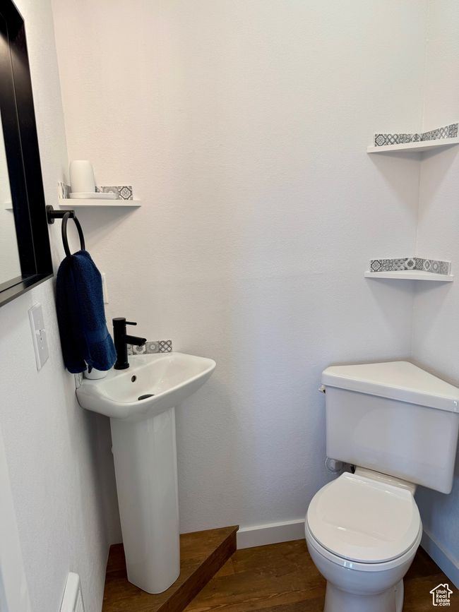 Bathroom toilet, sink and wood-type floors | Image 19