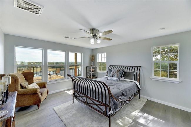 Bedroom featuring baseboards, wood finished floors, and a ceiling fan | Image 11