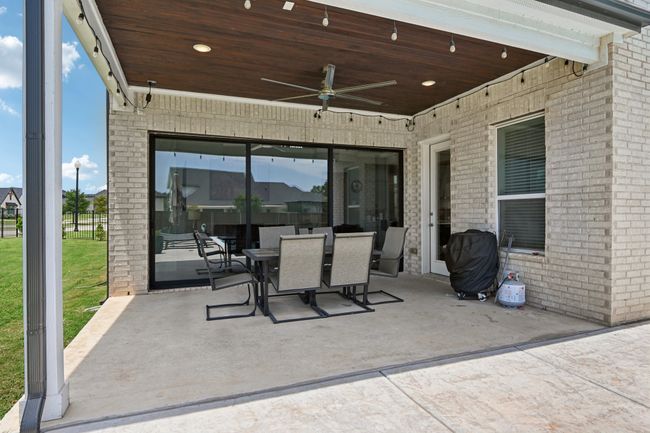 View of patio featuring ceiling fan and outdoor dining area | Image 35