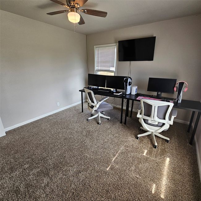 Office area featuring baseboards and a ceiling fan | Image 24