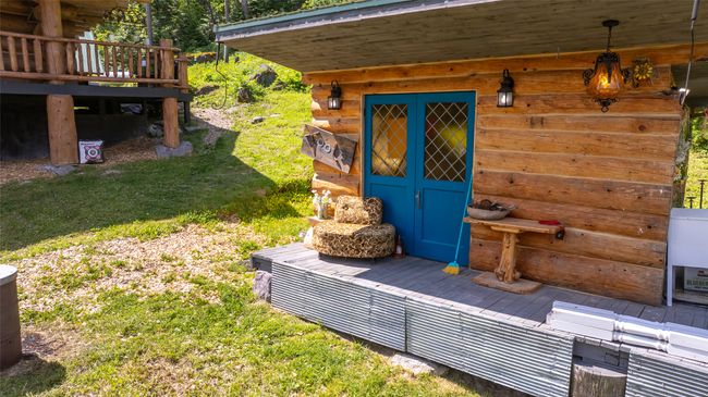 Property entrance featuring a lawn and a deck | Image 43