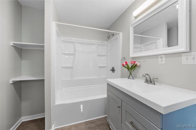 Bathroom with wood finished floors, shower combination, and vanity | Image 20