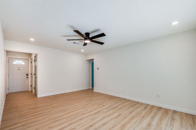 Unfurnished room featuring light wood-type flooring, ceiling fan, and recessed lighting | Image 14