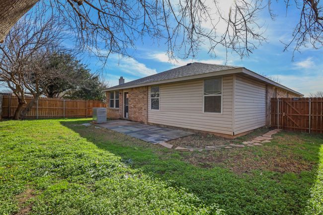 Rear view of house featuring a yard and a patio | Image 19
