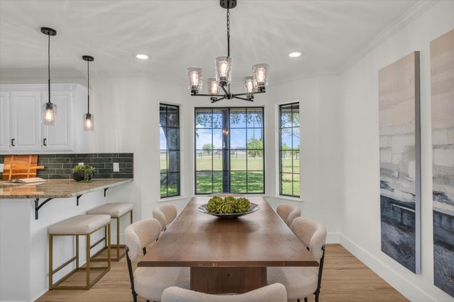 Dining room featuring recessed lighting, light wood-style floors, an inviting chandelier, and ornamental molding | Image 17