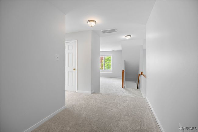 Corridor featuring an upstairs landing, visible vents, baseboards, and carpet floors | Image 24