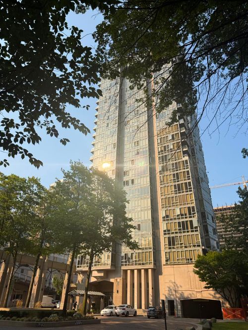 High-rise building featuring a glass and concrete facade | Card Image