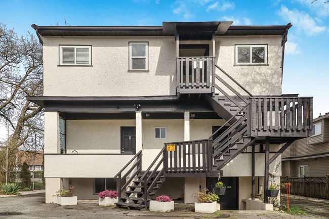 Rear view of house with stucco siding and stairs | Image 27
