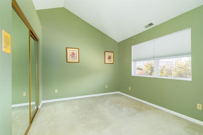 Unfurnished bedroom with lofted ceiling, light carpet, and a closet | Image 20