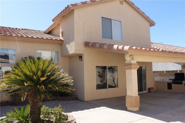 Rear view of property featuring a tile roof, a patio, and stucco siding | Image 69
