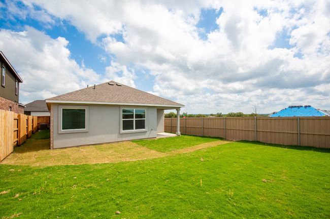 Rear view of house with stucco siding and roof with shingles | Image 27