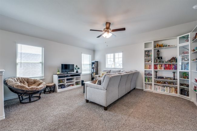 Living area featuring carpet floors, ceiling fan, and baseboards | Image 17
