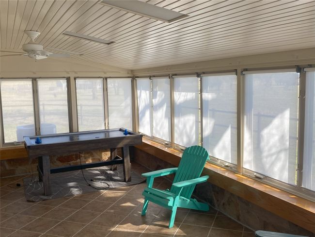 Sunroom / solarium with ceiling fan, and wood ceiling | Image 6