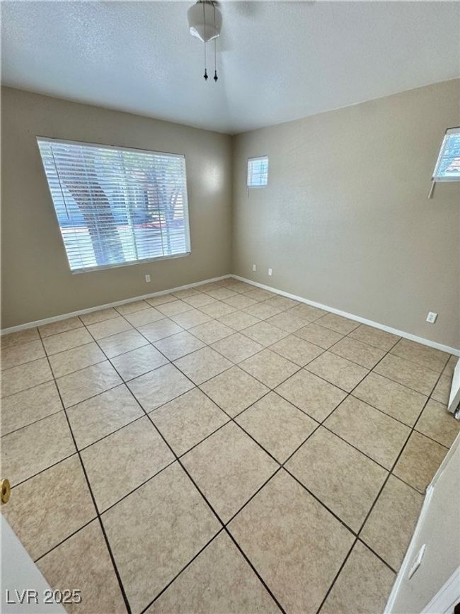 Unfurnished room featuring a textured ceiling, baseboards, and light tile patterned floors | Image 10