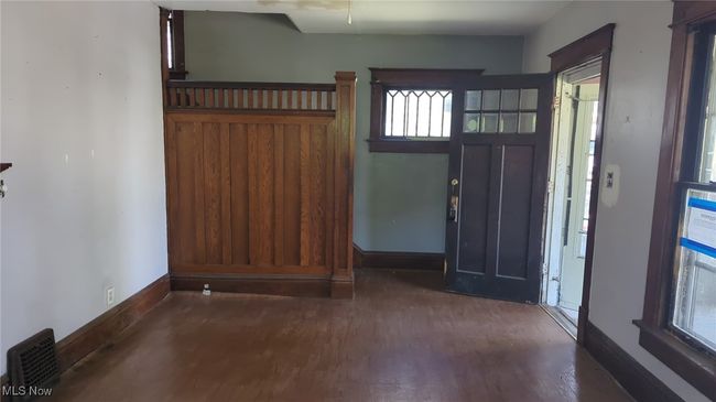 Foyer entrance featuring baseboards, visible vents, and wood finished floors | Image 6