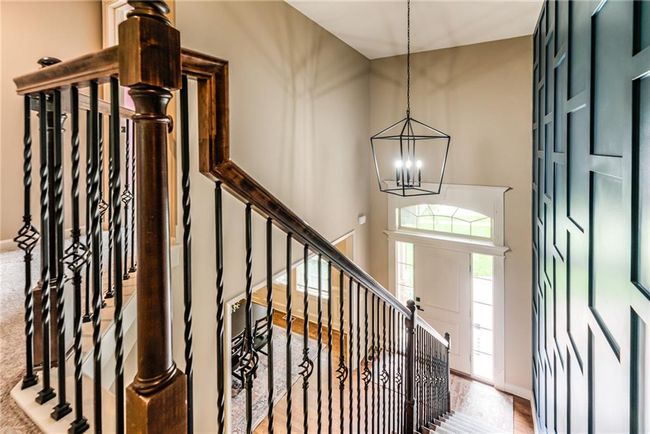 Staircase featuring a chandelier and baseboards | Image 22