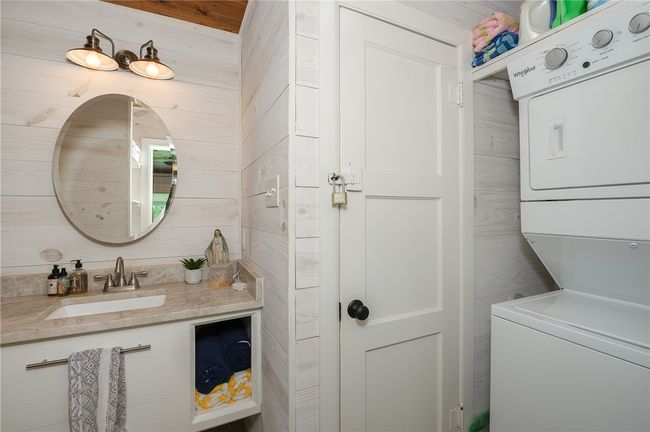 Bathroom with stacked washer / dryer and vanity | Image 46