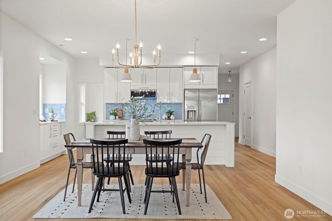 The dining room is very spacious and open to the living room and kitchen. The front entry is just to the right of the kitchen and down the hall. | Image 8