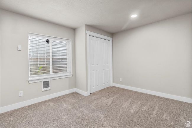Unfurnished bedroom with carpet, baseboards, a closet, and recessed lighting | Image 37
