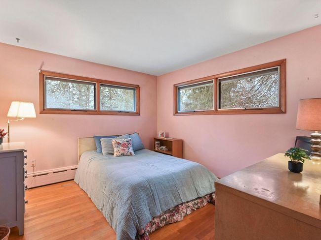 Bedroom with light hardwood / wood-style flooring and baseboard heating | Image 23