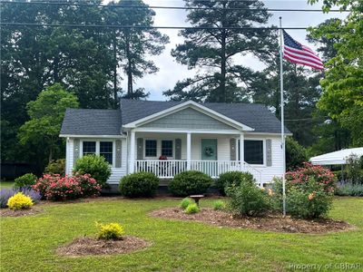 View of front of home with a front lawn and a porch | Image 1