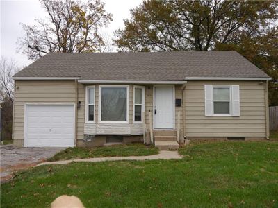 View of front of home featuring a garage and a front yard | Image 1