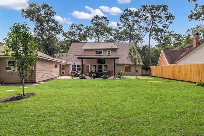 View of the backyard and home with detached garage. *Edited Grass | Image 39